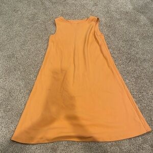 I’m selling an orange dress with short sleeves and never been more